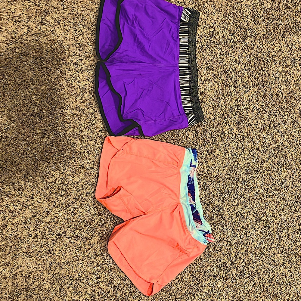 2 pairs of shorts, one is pink and one is purple.